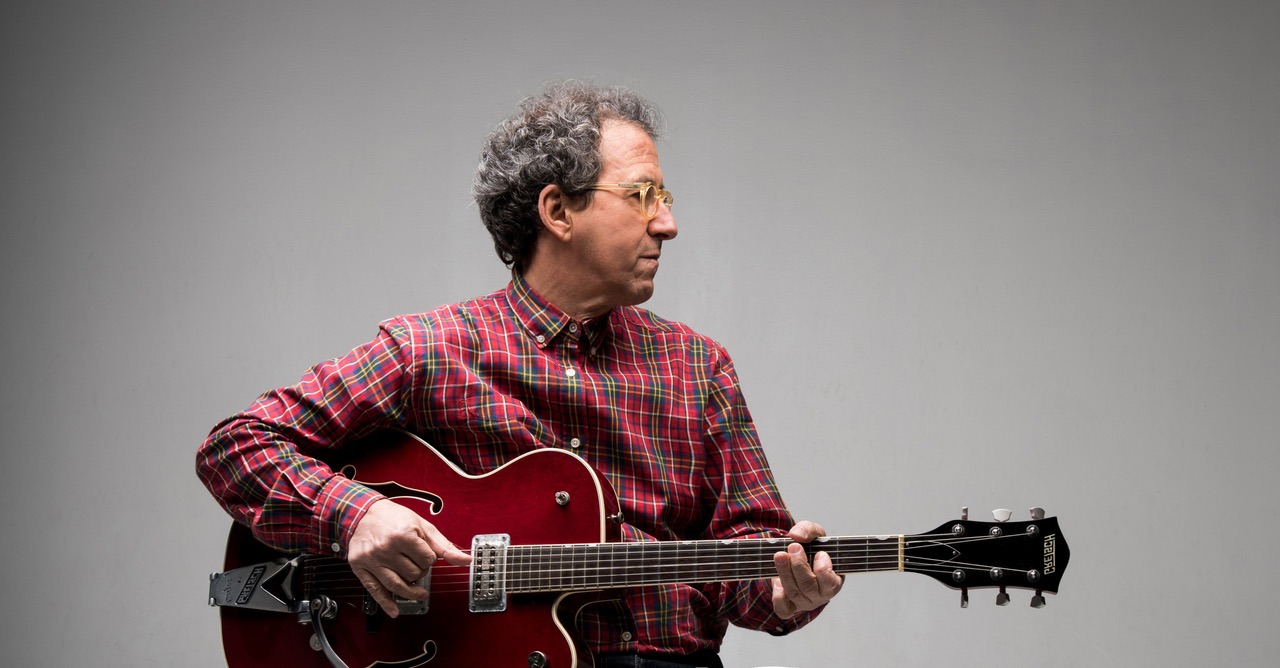 Imagem de Gimba com guitarra ao colo